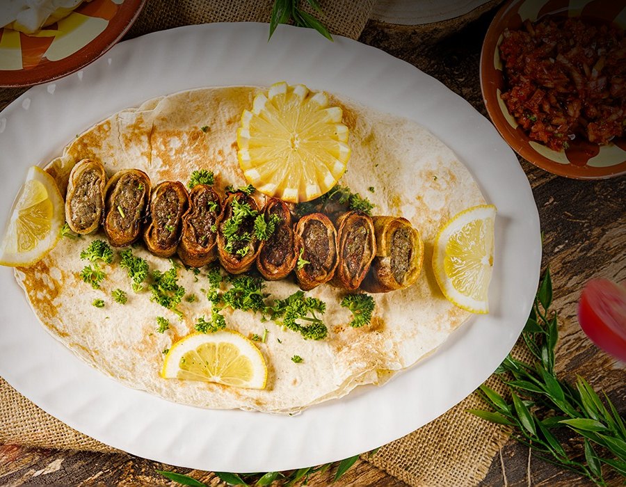 Crispy arayes stuffed pita served over hummus